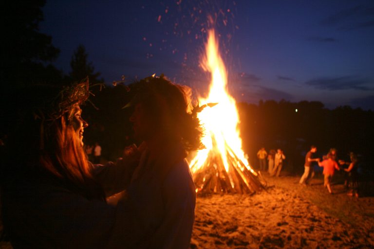 People dance around a campfire. (Vadim Rimakov/ AP Photo)