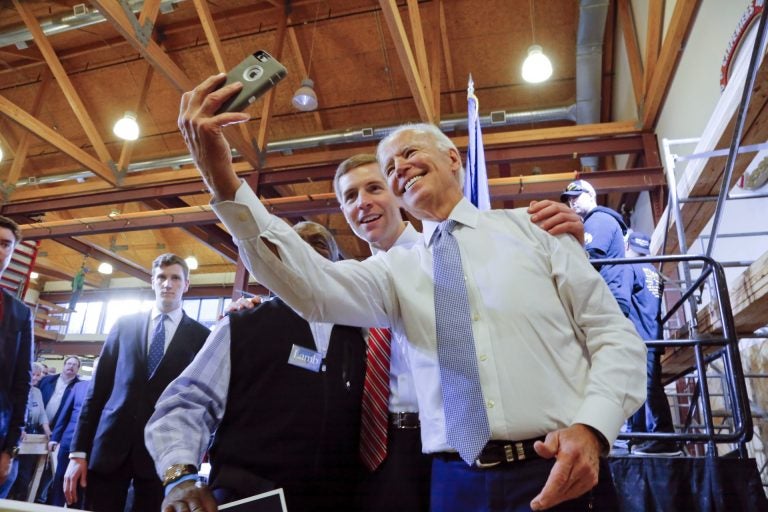 Conor Lamb, center, then a Democratic candidate for the March 13 special election in Pennsylvania's 18th Congressional District, and former Vice President Joe Biden, right, pose for a selfie with a supporter during a rally at the Carpenter's Training Center in Collier, Pa., Tuesday, March 6, 2018. (Gene J. Puskar / AP Photo)