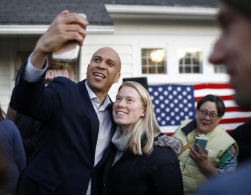 Democratic presidential candidate Sen. Cory Booker, D-N.J., poses for a selfie with an attendee after speaking at a campaign event at the home of Polk County Democratic Chair Sean Bagniewski, Tuesday, Jan. 7, 2020, in Des Moines, Iowa. (Patrick Semansky/AP Photo)