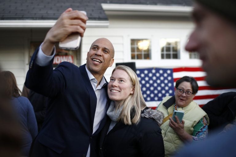 Democratic presidential candidate Sen. Cory Booker, D-N.J., poses for a selfie with an attendee after speaking at a campaign event at the home of Polk County Democratic Chair Sean Bagniewski, Tuesday, Jan. 7, 2020, in Des Moines, Iowa. (Patrick Semansky/AP Photo)