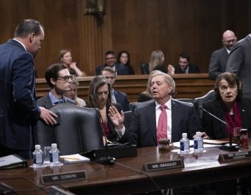 Senate Judiciary Committee Chairman Lindsey Graham, R-S.C., right, speaks with Sen. Mike Lee, R-Utah, a member of the panel, who criticized a security briefing on Iran Wednesday by Secretary of State Mike Pompeo and other top officials, saying it was 