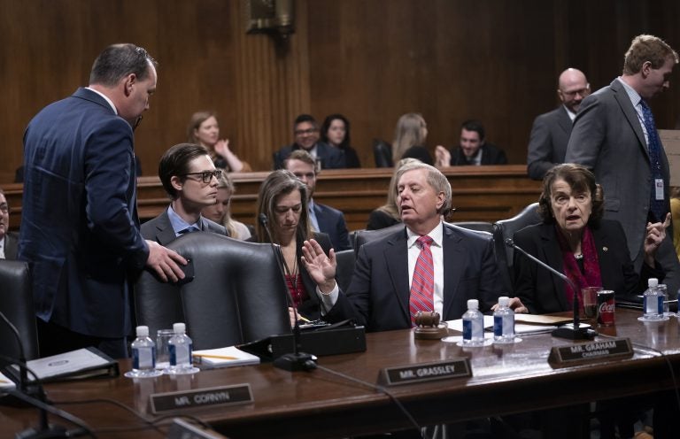 Senate Judiciary Committee Chairman Lindsey Graham, R-S.C., right, speaks with Sen. Mike Lee, R-Utah, a member of the panel, who criticized a security briefing on Iran Wednesday by Secretary of State Mike Pompeo and other top officials, saying it was 