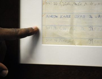 Jefferson County Sheriff Mark Pettway points out an old jail log showing the name of Dr. Martin Luther King Jr. in Birmingham, Ala. (Jay Reeves/AP Photo)