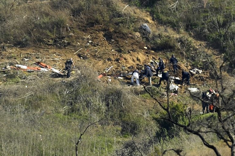 Investigators work the scene of a helicopter crash