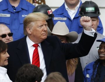 President Donald Trump pumps his fist after signing a new North American trade agreement with Canada and Mexico, during an event at the White House, Wednesday, Jan. 29, 2020, in Washington. (Alex Brandon/AP Photo)