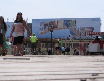 This July 3, 2015 photo shows people walking on the Boardwalk in Atlantic City N.J. On Jan. 30, 2020, top executives from eight of the city's nine casinos said Atlantic City needs to be cleaned up and made safer before business conditions will improve. (Wayne Parry/AP Photo)