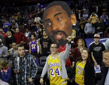 Fans of Los Angeles Lakers' Kobe Bryant watch him practice ahead of a basketball game against the Philadelphia 76ers Tuesday, Dec. 1, 2015, in Philadelphia. (AP Photo/Matt Rourke)