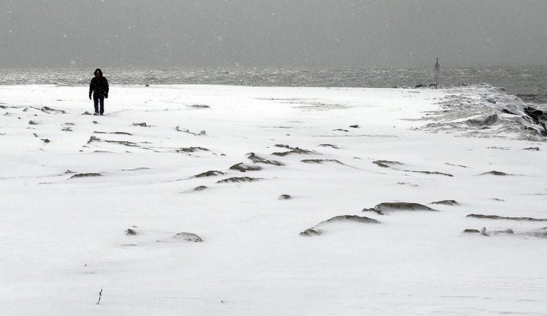 Ken Phillips walks on a snow-covered beach at 2nd Avenue in Cape May, N.J., Thursday, Feb. 26,  2015. (AP Photo/The Press of Atlantic City, Dale Gerhard) 