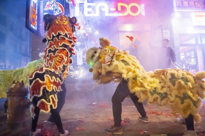 Members of the Philadelphia Suns perform in front of Tea Do on 10th Street in Chinatown. (Jonathan Wilson for WHYY)