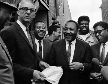 Dr. Martin Luther King Jr., center, and Rev. Ralph Abernathy, third from left, share a laugh outside  court in Decatur, Ga., Oct. 25, 1960. Others are unidentified. Andrew Young is seen at center, facing right. (AP Photo)