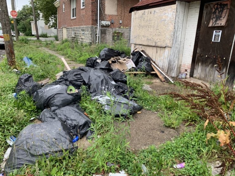 Bagged construction material dumped in front of a 