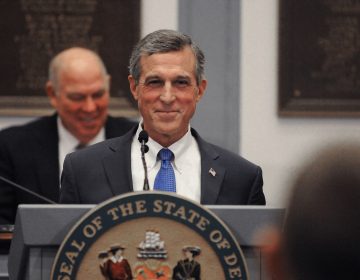 Delaware Governor John Carney grins during his 2020 State of the State address at Legislative Hall in Dover, Delaware on Thursday, Jan. 23, 2020.  (Butch Comegys for WHYY)