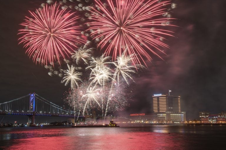 Fireworks are launched from a barge in the Delaware River as seen from Penns Landing.(Jonathan Wilson for WHYY)