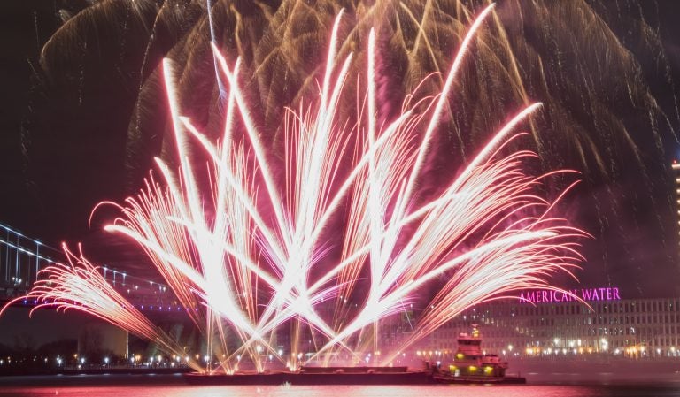 Fireworks are launched from a barge during the midnight display at Penn's Landing. (Jonathan Wilson for WHYY)