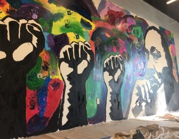 A new mural honoring Dr. Martin Luther King Jr. was finished by student volunteers at The Warehouse, a new teen center opening soon in northeast Wilmington. (Mark Eichmann/WHYY)