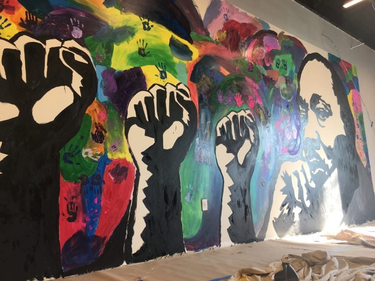 A new mural honoring Dr. Martin Luther King Jr. was finished by student volunteers at The Warehouse, a new teen center opening soon in northeast Wilmington. (Mark Eichmann/WHYY)