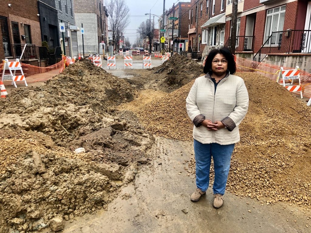 Domenica Federico stands near her home, surrounded by rubble