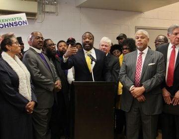 Philadelphia City Councilman Kenyatta Johnson is surrounded by supporters at a press conference where he declares his innocence after the announcement on Wednesday of federal corruption charges against him and his wife. (Emma Lee/WHYY)