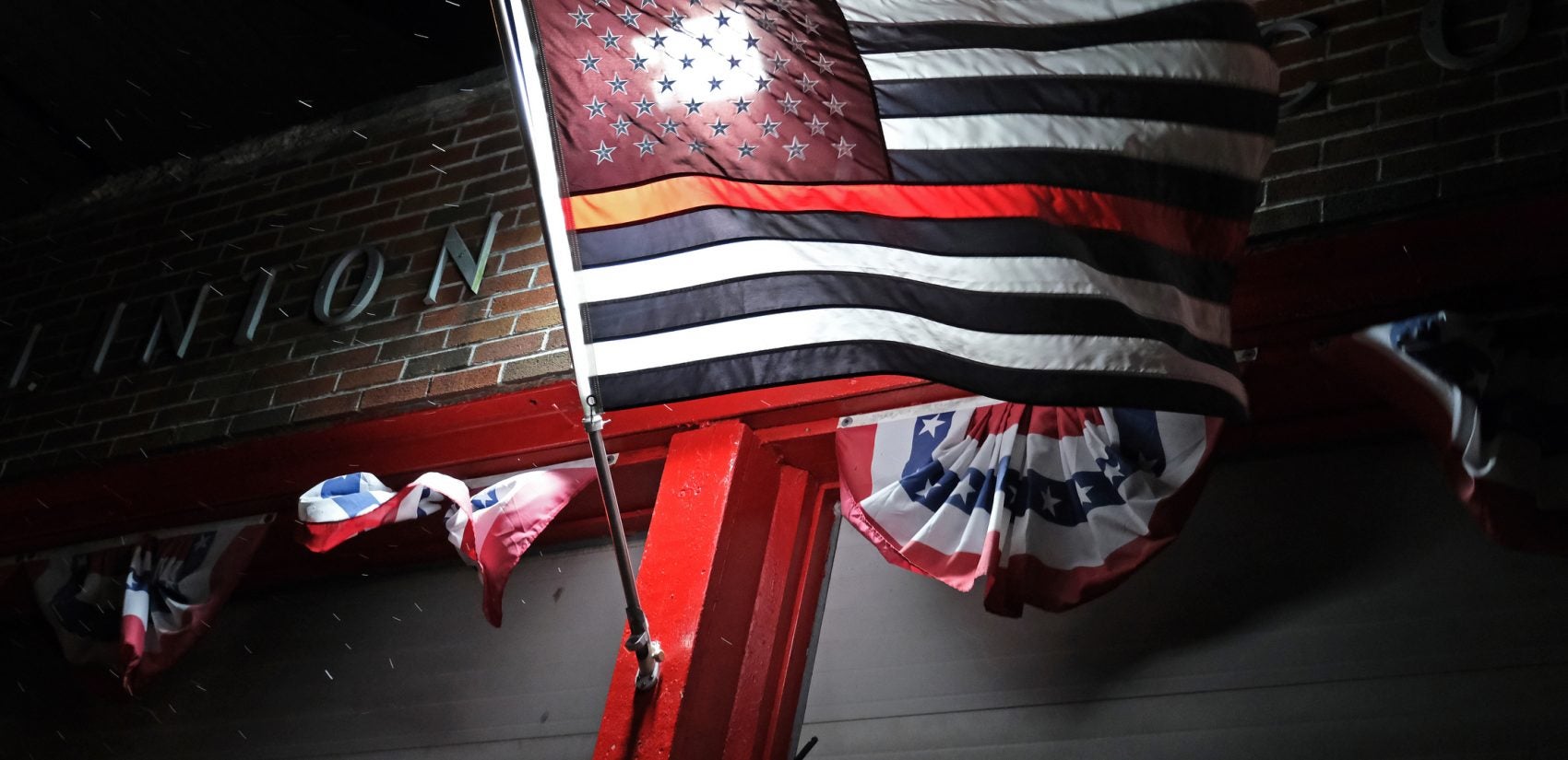 A 'Thin Red Line' flag flies outside of the Port Clinton Fire Company in Schuylkill County. (Matt Smith for Keystone Crossroads)