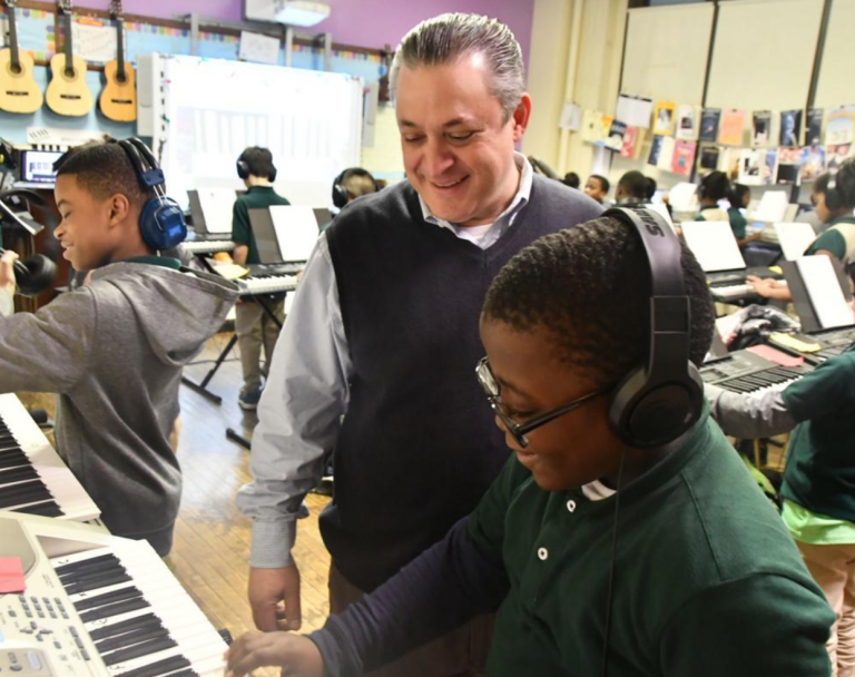 Music teacher Marc Dulberg watches as Amir Newsome plays the keyboard in class. (Abdul Sulayman/The Philadelphia Tribune)