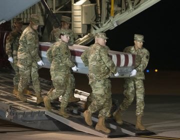 An Air Force team moves a transfer case containing the remains of one of the young sailors killed after a Saudi military student opened fire at a Pensacola naval base last month. (Cliff Owen/AP Photo)