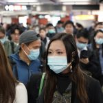 Passengers in a subway station in Hong Kong on Wednesday wear masks amid the coronavirus outbreak. (Kin Cheung/AP)