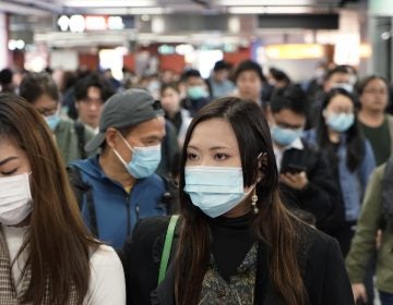 Passengers in a subway station in Hong Kong wear masks amid the coronavirus outbreak. (Kin Cheung/AP Photo)