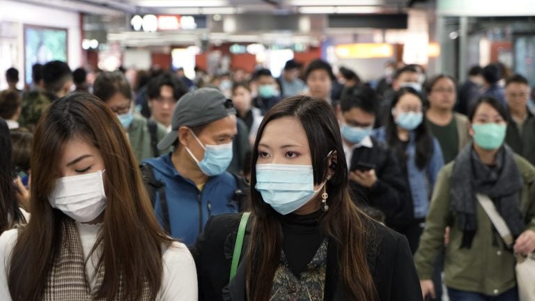 Passengers in a subway station in Hong Kong wear masks amid the coronavirus outbreak. (Kin Cheung/AP Photo)