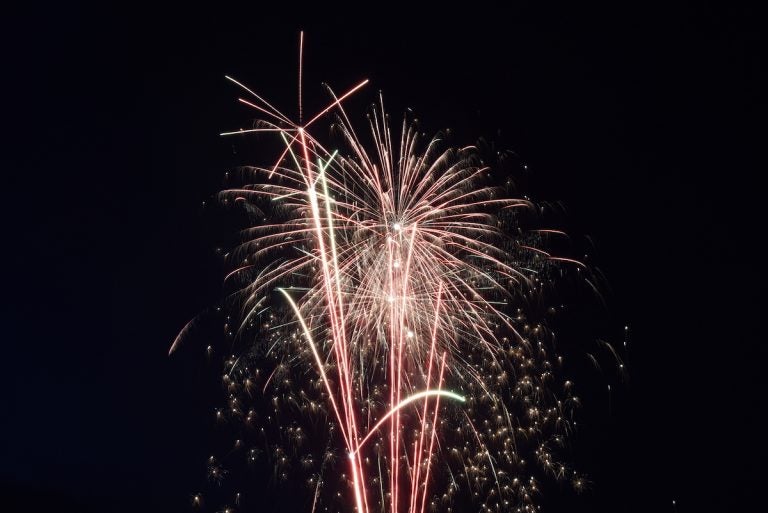 Fireworks With A Dark Black Background, Bright Beautiful Colorful Firework. Colored Firework Lights