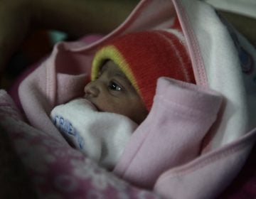 A 5-pound newborn girl is swaddled in a blanket in a hospital in Islamabad, Pakistan. She was born on Jan. 1, 2020. (Diaa Hadid)