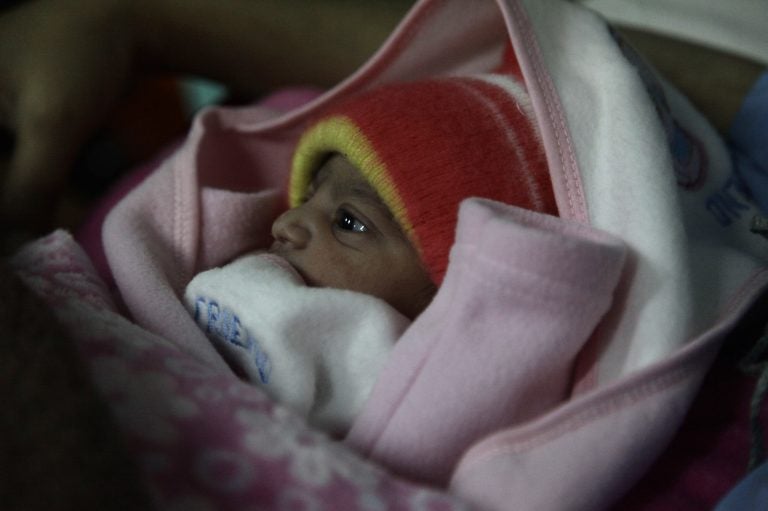 A 5-pound newborn girl is swaddled in a blanket in a hospital in Islamabad, Pakistan. She was born on Jan. 1, 2020. (Diaa Hadid)
