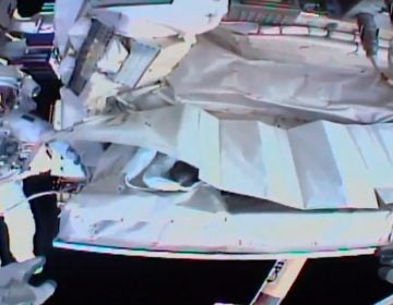 This photo provided by NASA shows the view from NASA's Andrew Morgan's helmet cam as Italian astronaut Luca Parmitano works outside the International Space Station during a spacewalk Saturday. (AP Photo)