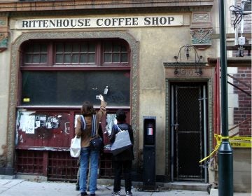 Two curious passersby study the former Rittenhouse Coffee Shop building at 1904 Sansom Street in 2005. (Elston via Flickr)