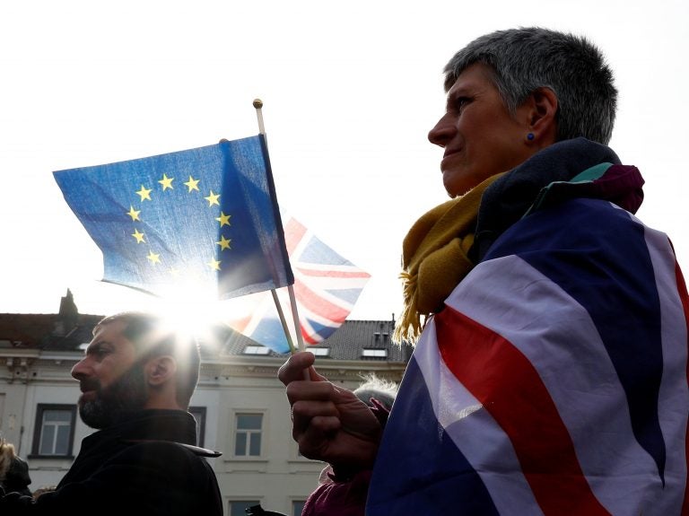 An anti-Brexit demonstrator holds British and European Union flags during a protest in front of the European Parliament in Brussels on Thursday. (Francois Lenoir/Reuters)