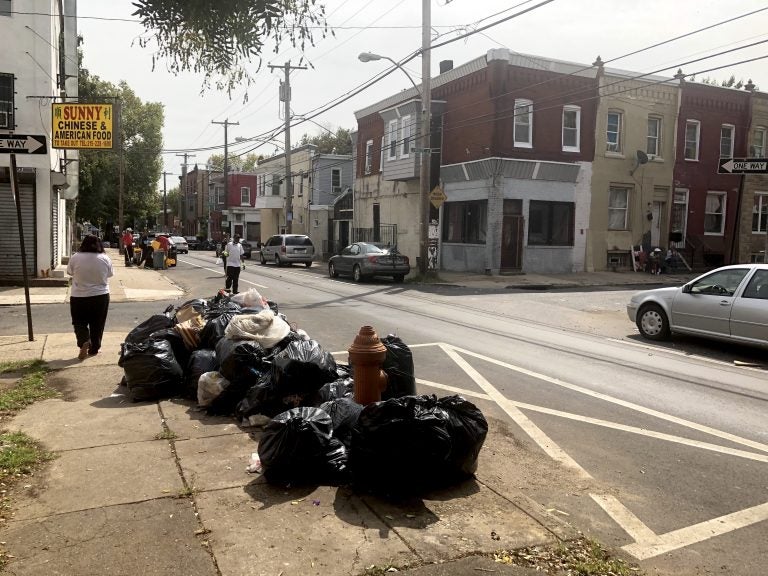 Street cleaners organized by the Black Male Community Council of Philadelphia work on a North Philadelphia block. (Black Male Community Council of Philadelphia) 