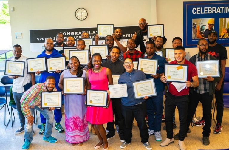 Graduates of a training course sponsored by the Post Bros. celebrate their graduation at the local community center. (Richard Allen New Generation)