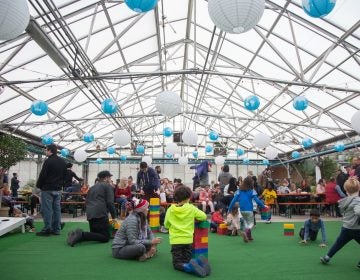 Children romp and play on the 'lawn' at the Getaway at the Greenhouse. (Emily Cohen for WHYY)