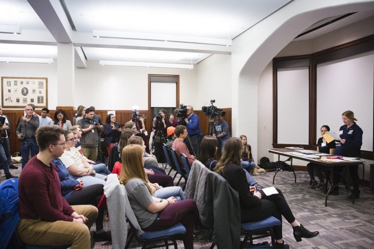 Fourteen Iowa residents partake in a satellite Iowa caucus at the University of Pennsylvania on February 3, 2020. The group ultimately assigned two delegate votes to Bernie Sanders, one to Elizabeth Warren, and one to Pete Buttigieg. (Rachel Wisniewski for WHYY)