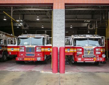 Fire trucks are parked inside Liberty Fire Station on Broadway in Camden, N.J.  (Miguel Martinez for WHYY)