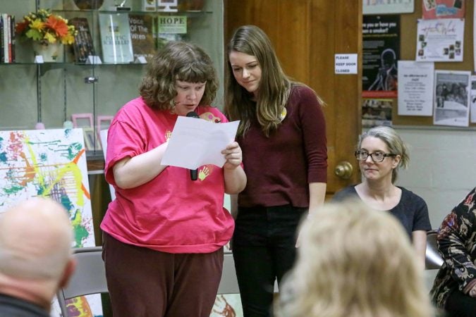 Emily Roark (left) gives remarks during an art therapy exhibit on Feb. 10, 2020, at The Art Studio in Wilmington, Del. (Saquan Stimpson for WHYY)