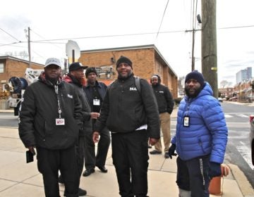 Twenty PAAN members canvassed the neighborhood offering city resources after a quadruple shooting rocked the community Wednesday. (Ximena Conde/WHYY)