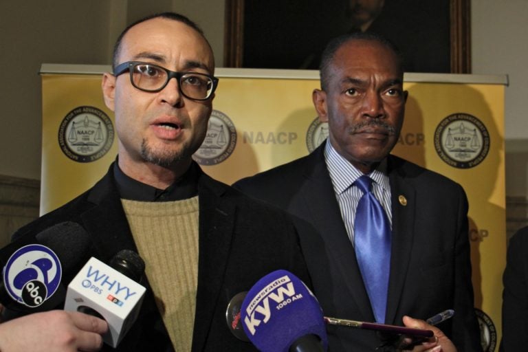 The NAACP has filed suit on behalf of Robert Holbrook (left) and other currently and formerly incarcerated people whose Census numbers apply to the community where they are incarcerated rather than where they live. Holbrook spoke during a press conference at City Hall, accompanied by Philadelphia NAACP President Rodney Muhammad (right). (Emma Lee/WHYY)