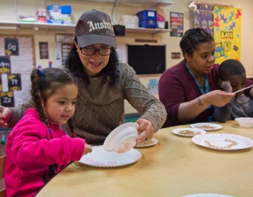 Kids in SPIN’s autism support preschool classroom work on their motor skills by creating a marshmallow fluff and Cheerio heart craft project. (Kimberly Paynter/WHYY)
