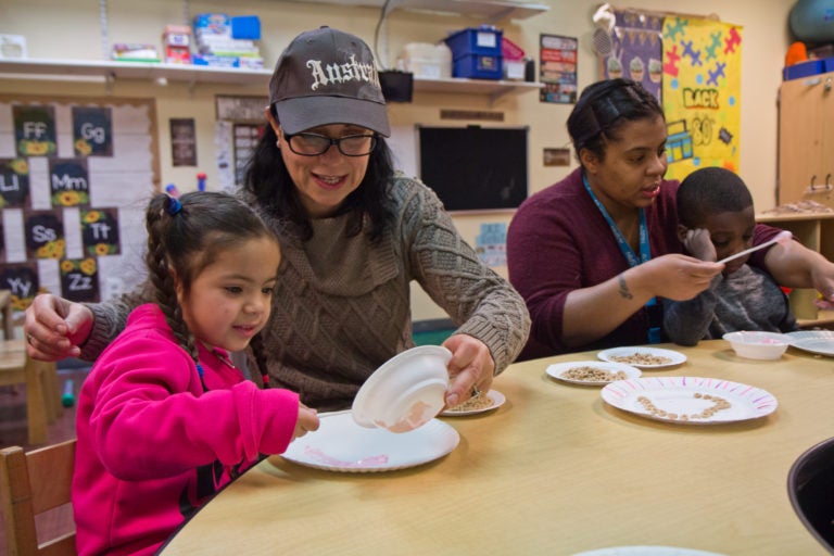 Kids in SPIN’s autism support preschool classroom work on their motor skills by creating a marshmallow fluff and Cheerio heart craft project. (Kimberly Paynter/WHYY)