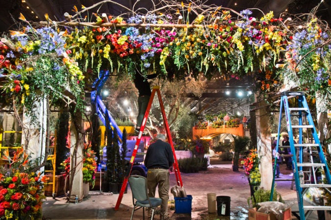 PHS staff work to finish the main exhibit of the Philadelphia Flower Show Thursday. (Kimberly Paynter/WHYY)