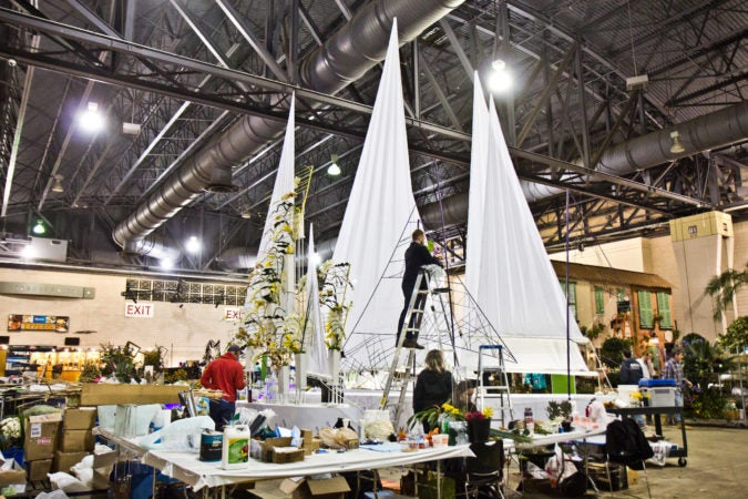 “On the Sea” a design by Haddonfield’s Arrange, Floral and Event Design, being built Thursday at the 2020 Flower Show. (Kimberly Paynter/WHYY)