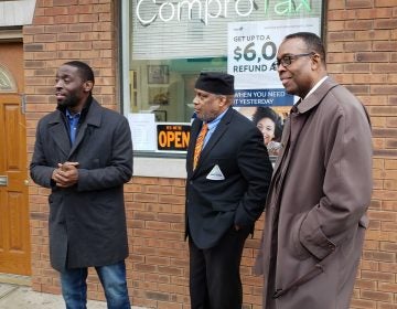 Councilmembers Isaiah Thomas (left) and Darrell Clarke (right) with ComproTax owner Timothy Nelson. (Tom MacDonald/WHYY)