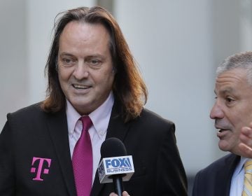 T-Mobile chief executive John Legere speaks to reporters as he leaves the courthouse in New York, Wednesday, Jan. 15, 2020. Legere was in court to hear closing arguments in the case that could permit T-Mobile to merge with Sprint. (AP Photo/Seth Wenig)