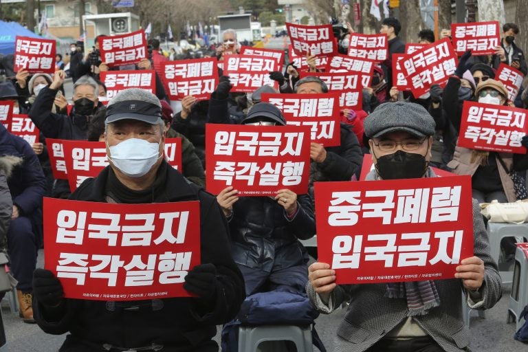In this Wednesday, Jan. 29, 2020, photo, South Korean protesters stage a rally calling for a ban on Chinese people entering South Korea near the presidential Blue House in Seoul, South Korea. (Ahn Young-joon/AP Photo)