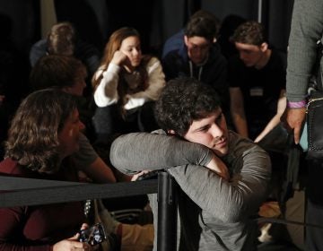 People wait for results at a caucus night campaign rally for democratic presidential candidate former Vice President Joe Biden on Monday, Feb. 3, 2020, in Des Moines, Iowa. (AP Photo/John Locher)